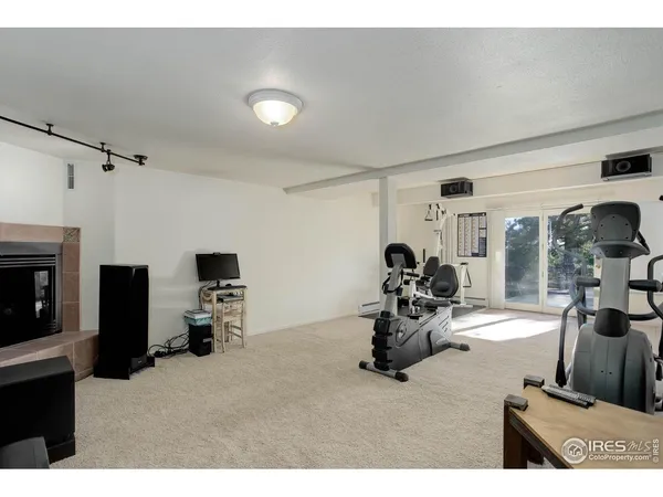 a room with gym equipment and a view of living room