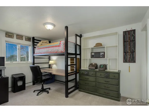 a living room with furniture a window and a wooden floor