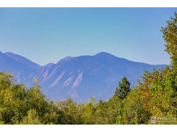 a backyard of a house with a garden and outdoor seating
