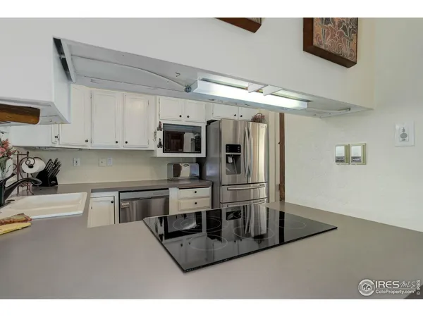 a kitchen with refrigerator and cabinets
