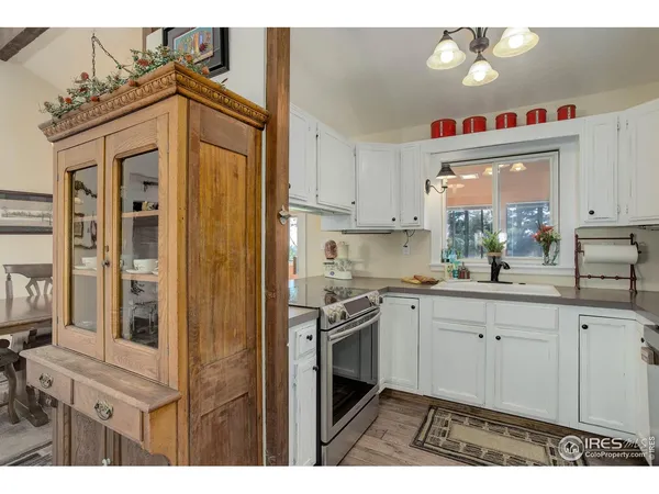 a view of a dining room with furniture a chandelier and wooden floor