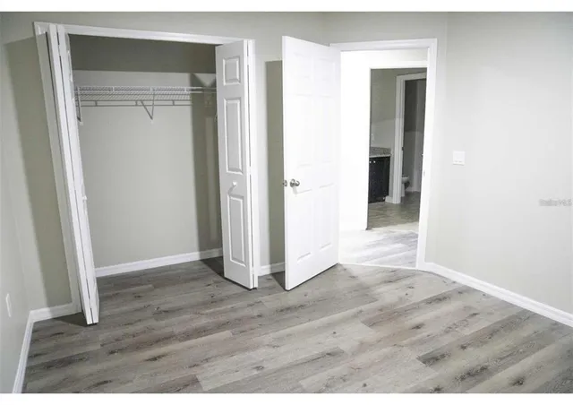 a view of hallway with wooden floor