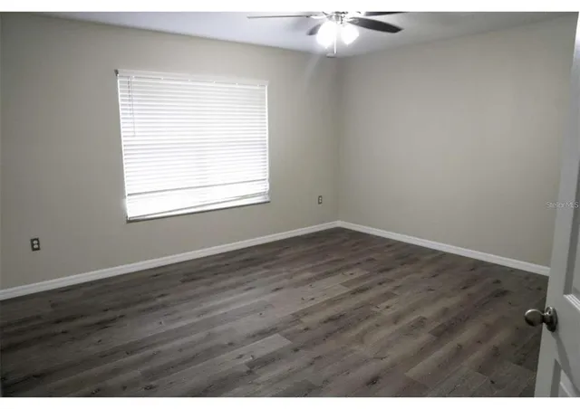 an empty room with wooden floor