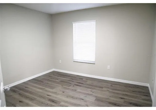 an empty room with wooden floor