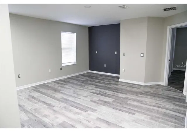a view of room window and wooden floor