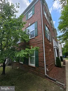 a view of a brick house with a yard