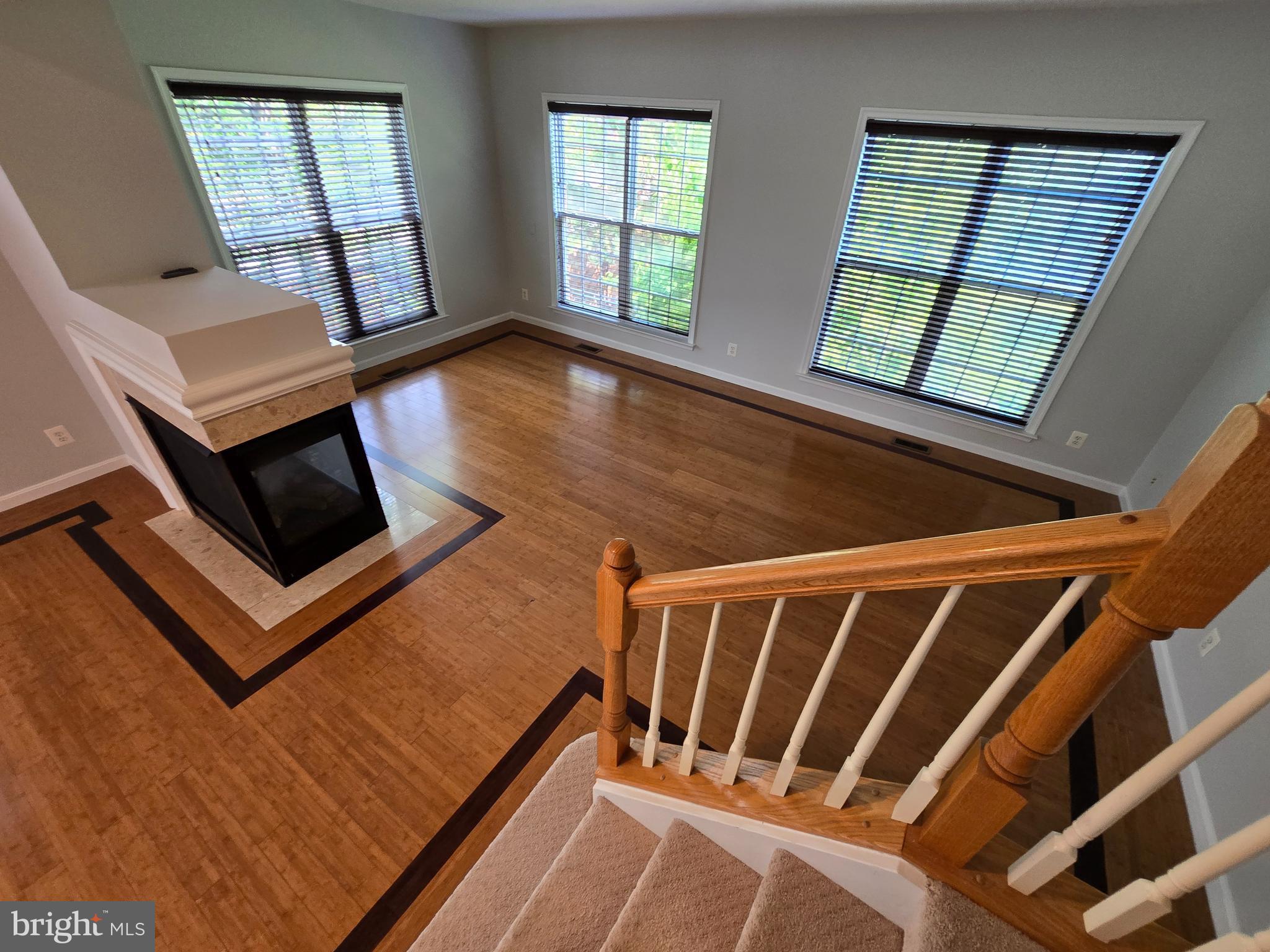 5019 Village Fountain Place Centreville, VA 20120 - Photo 15 of 17 a view of an empty room with wooden floor and a window