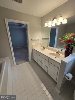 a bathroom with a sink vanity and mirror