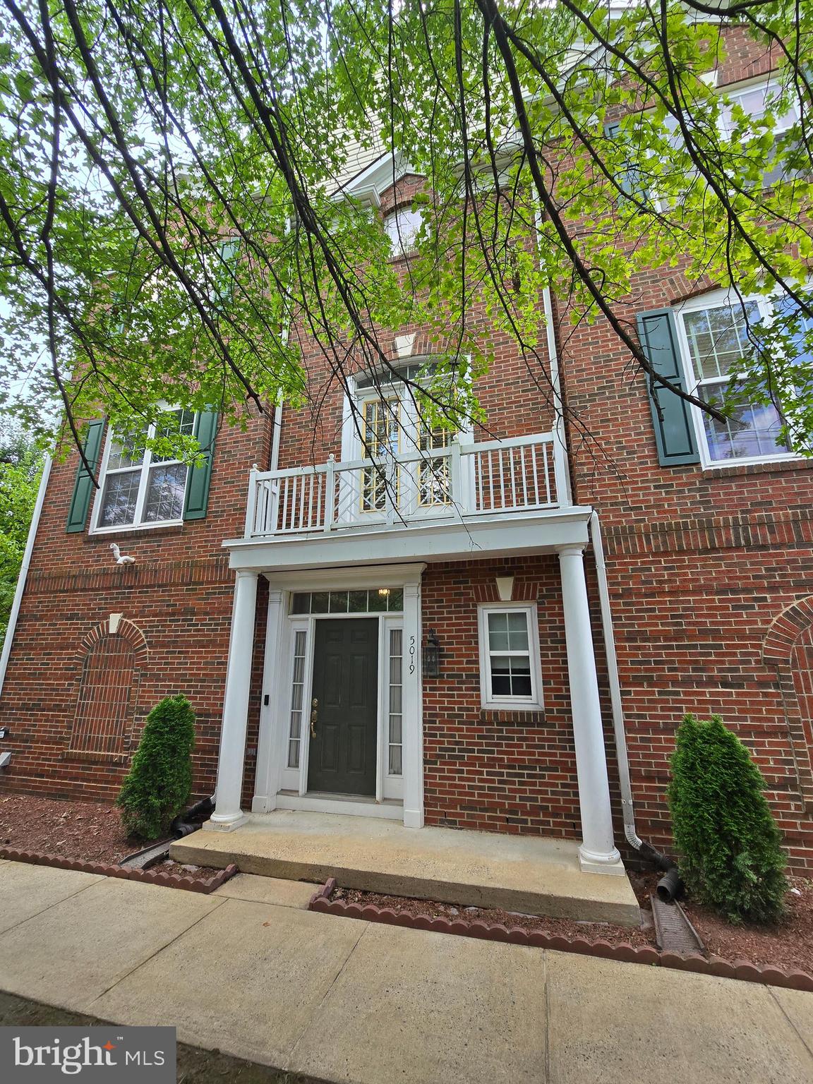 5019 Village Fountain Place Centreville, VA 20120 - Photo 3 of 17 a front view of a house with a garage