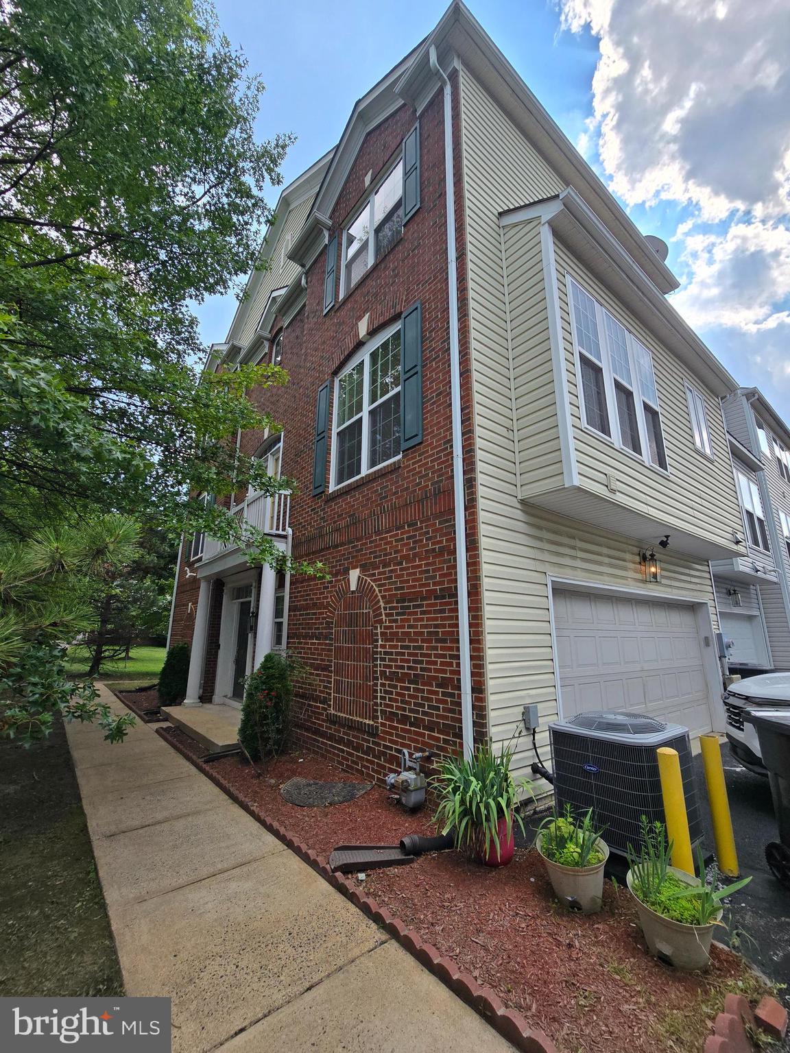 5019 Village Fountain Place Centreville, VA 20120 - Photo 4 of 17 a front view of a house with garden