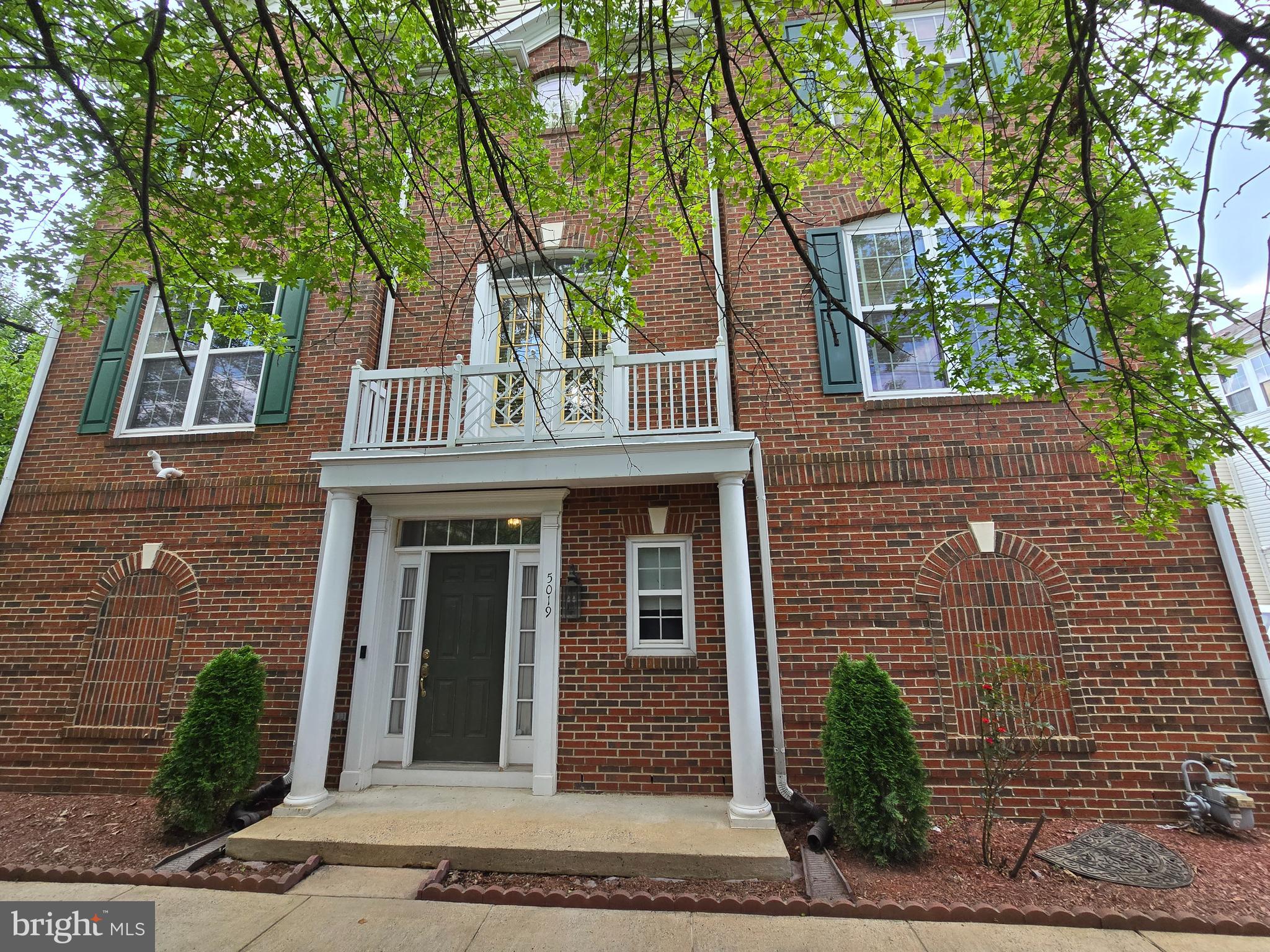 5019 Village Fountain Place Centreville, VA 20120 - Photo 5 of 17 a front view of a house with a tree