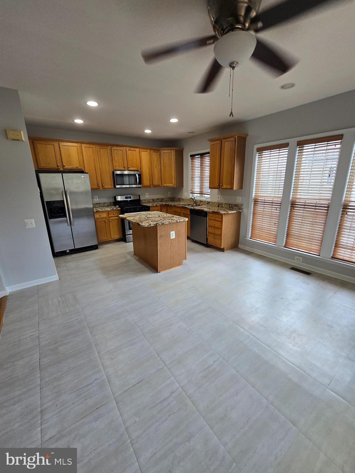 5019 Village Fountain Place Centreville, VA 20120 - Photo 10 of 17 a living room with stainless steel appliances furniture and a kitchen view