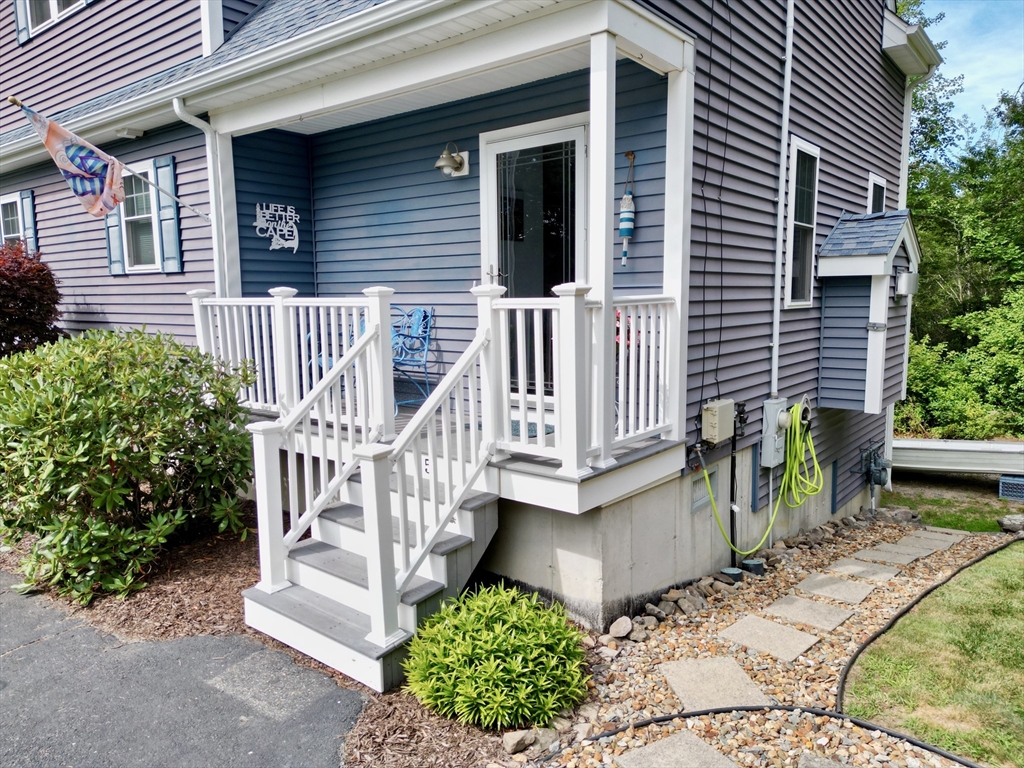 5 Wilson Street Wareham, MA 02571 - Photo 11 of 37 a view of a house with a small yard and wooden fence