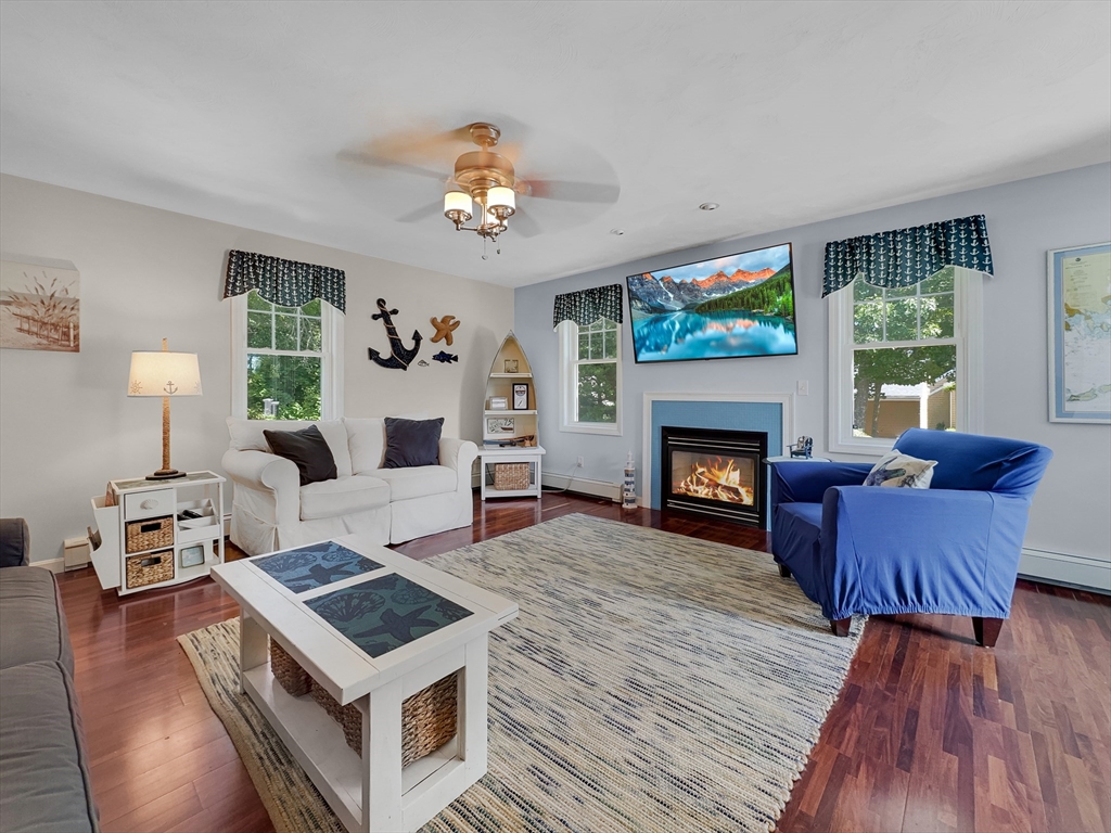 5 Wilson Street Wareham, MA 02571 - Photo 13 of 37 a living room with furniture a fireplace and a flat screen tv