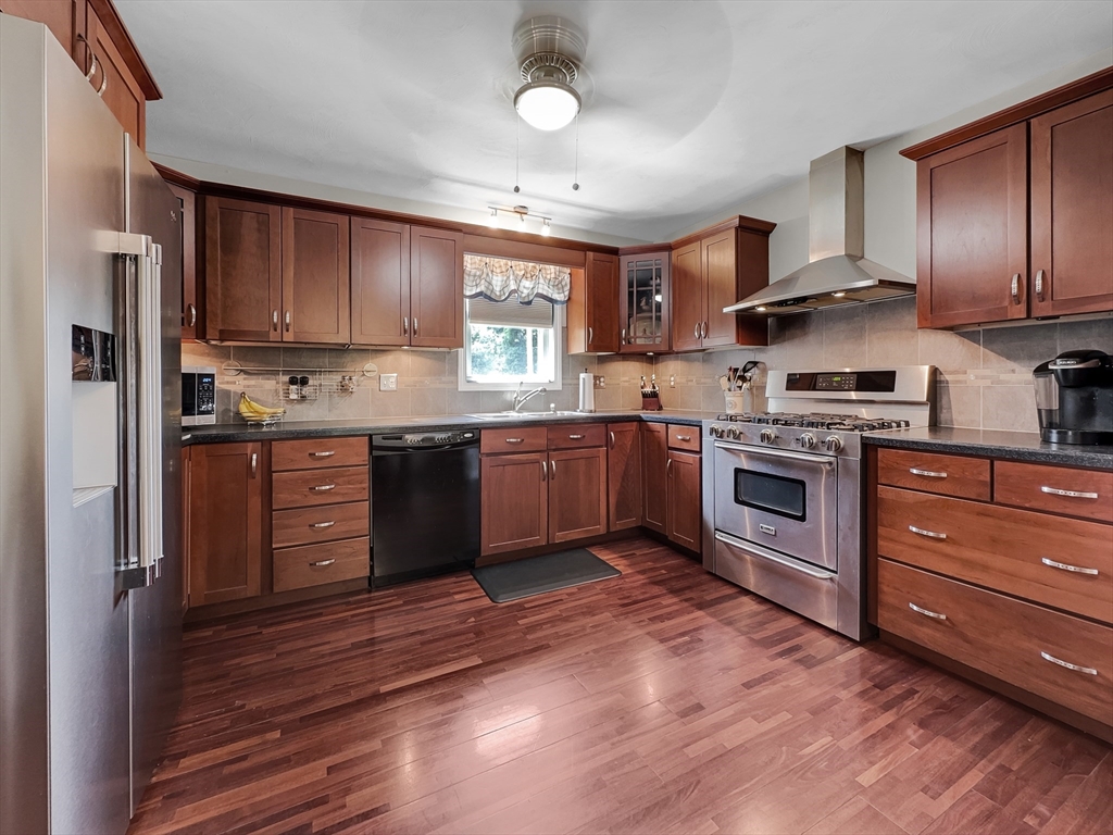 5 Wilson Street Wareham, MA 02571 - Photo 18 of 37 a kitchen with stainless steel appliances granite countertop wooden cabinets stove top oven and sink