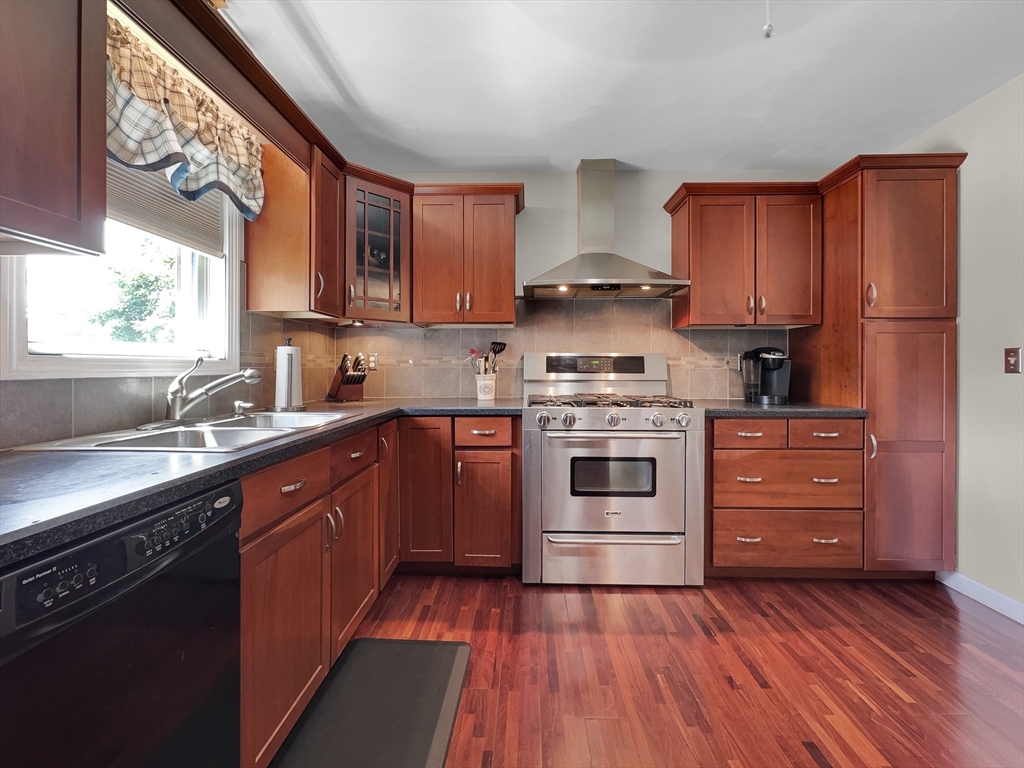 5 Wilson Street Wareham, MA 02571 - Photo 20 of 37 a kitchen with wooden floors and white appliances