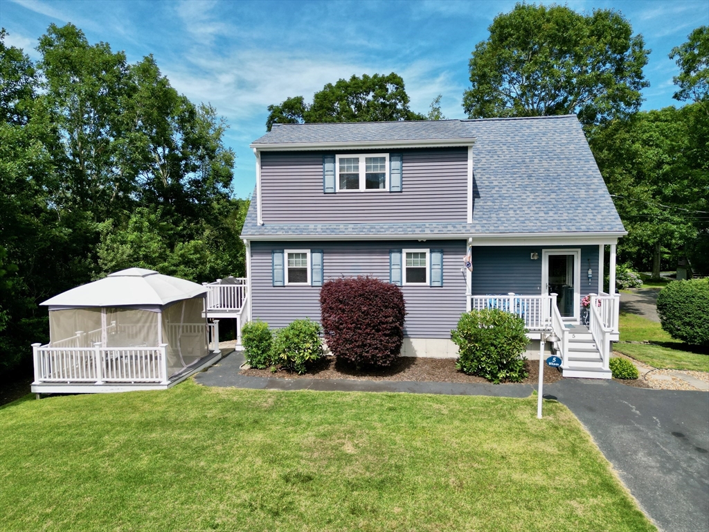 5 Wilson Street Wareham, MA 02571 - Photo 2 of 37 a front view of a house with a yard and garage