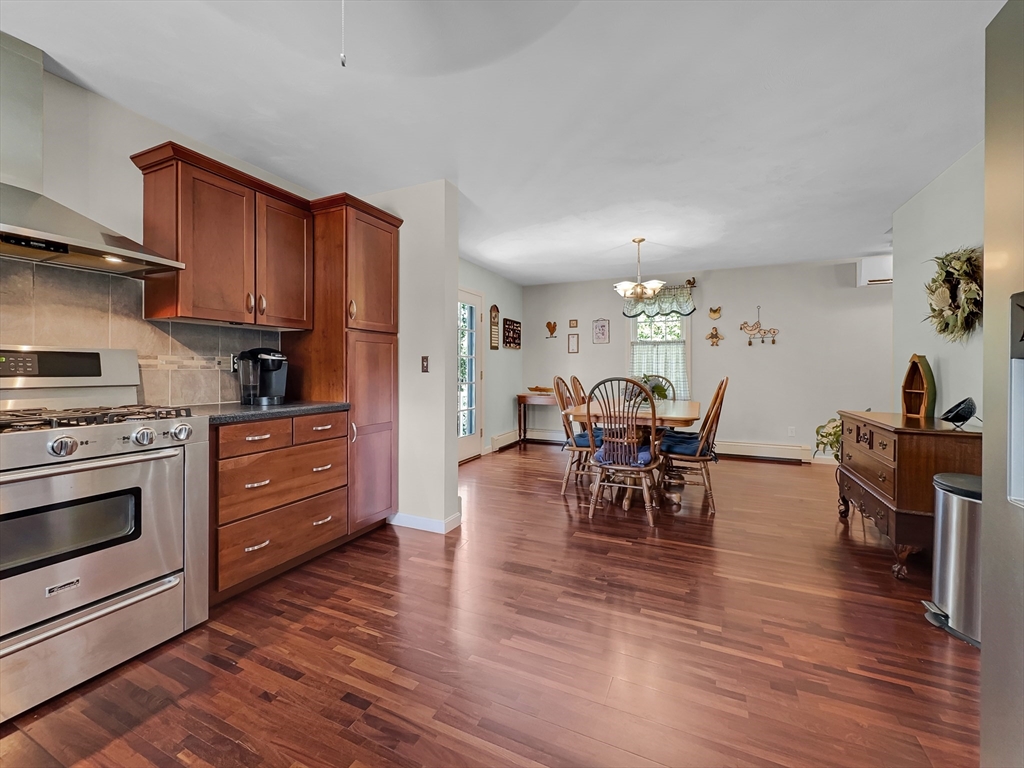5 Wilson Street Wareham, MA 02571 - Photo 21 of 37 a kitchen with stainless steel appliances granite countertop wooden floors and cabinets
