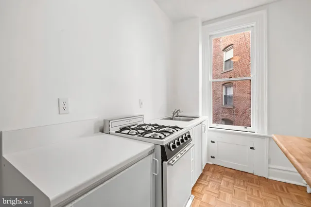 a kitchen that has a stove and a microwave