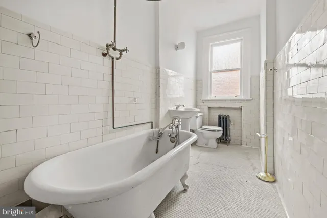 a white bath tub sitting next to a white sink