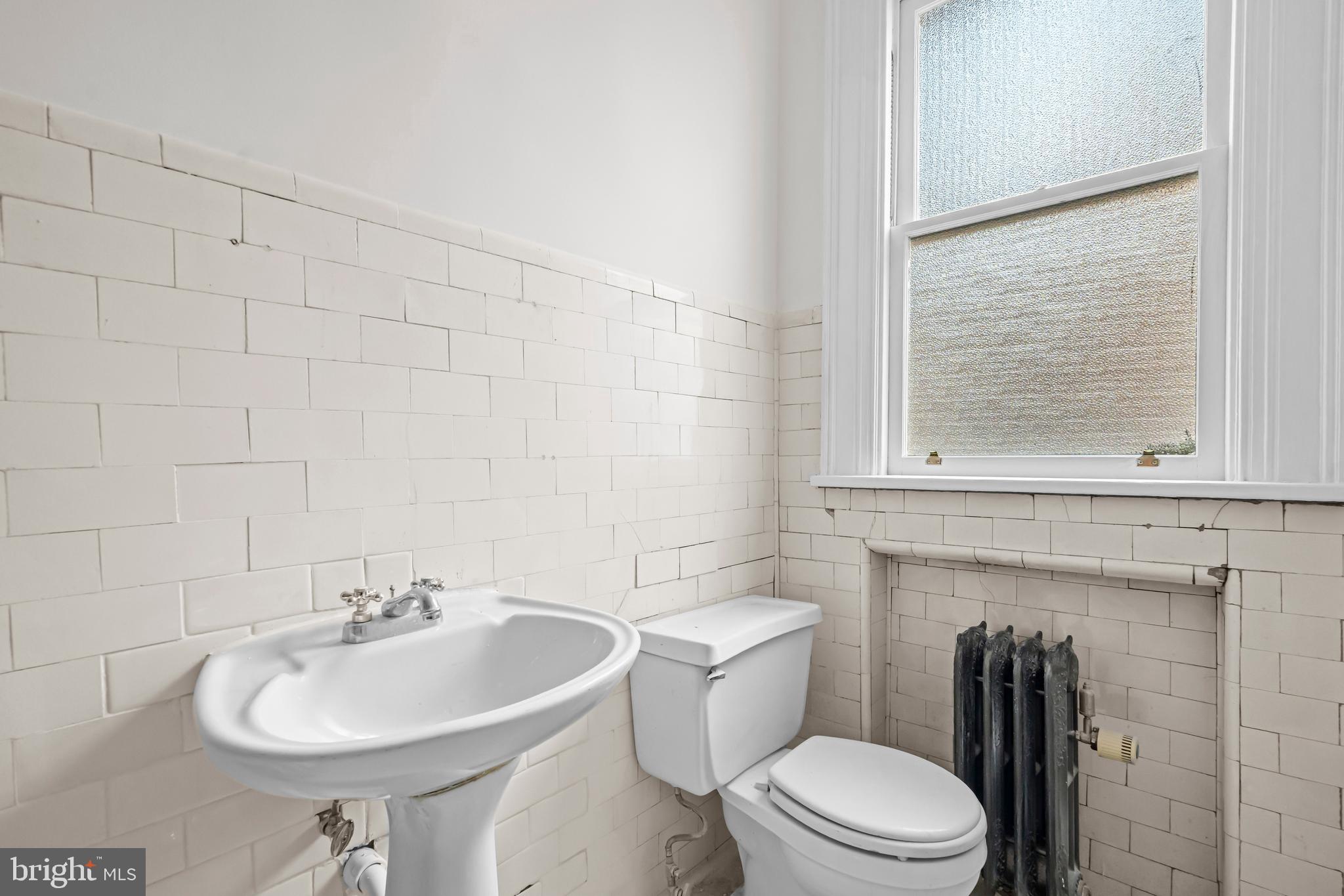 2039 New Hampshire Avenue Northwest, Unit 607 Washington, DC 20009 - Photo 17 of 20 a bathroom with a sink a toilet and mirror