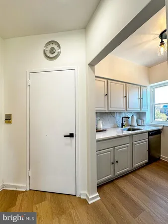 a kitchen with a refrigerator and a sink