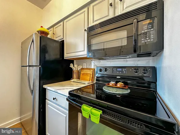 a kitchen with a stove and a refrigerator