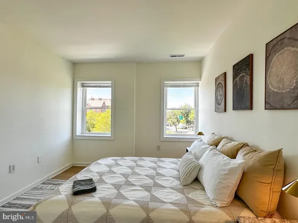 a bedroom with a bed and a window