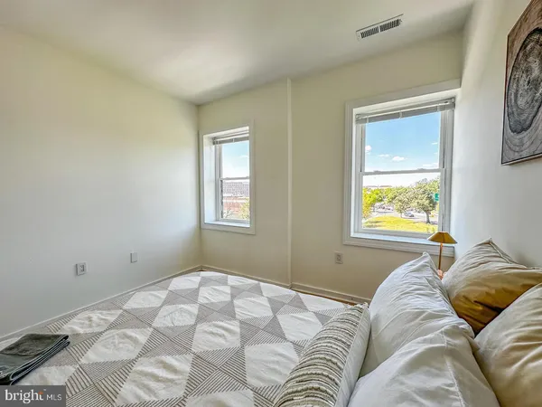 a bedroom with a bed and a window