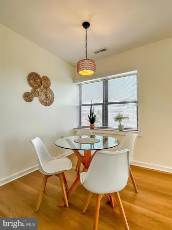 a dining room with furniture and a window