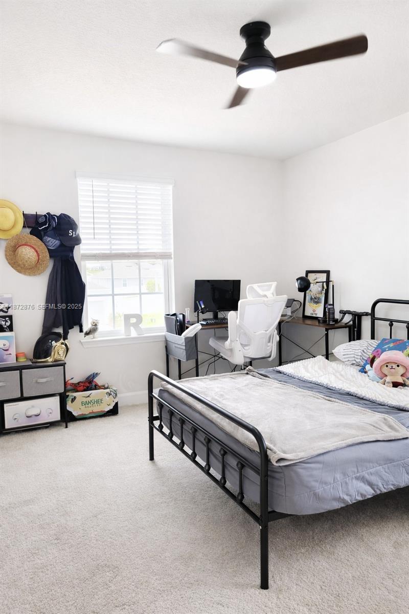 2118 Aibonito Circle Clermont, FL 34711 - Photo 15 of 17 a bedroom with bed and window