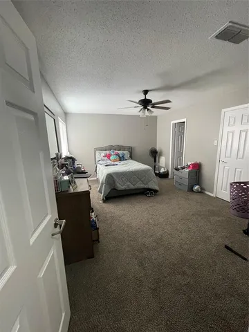 a living room with furniture and a gym machine