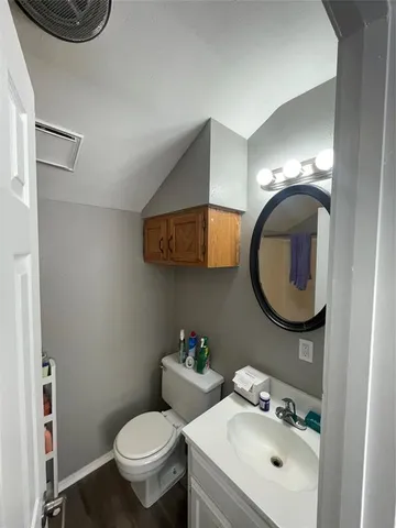 a bathroom with a toilet sink and mirror
