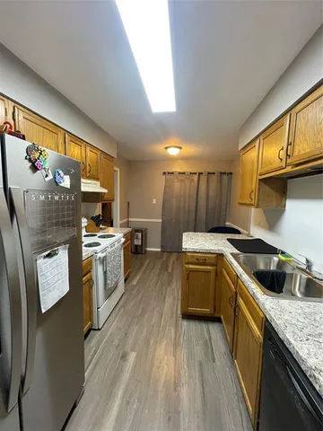 a kitchen with a sink stove top oven and cabinets