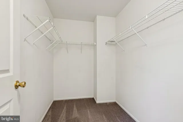 a view of storage and utility room with wooden floor