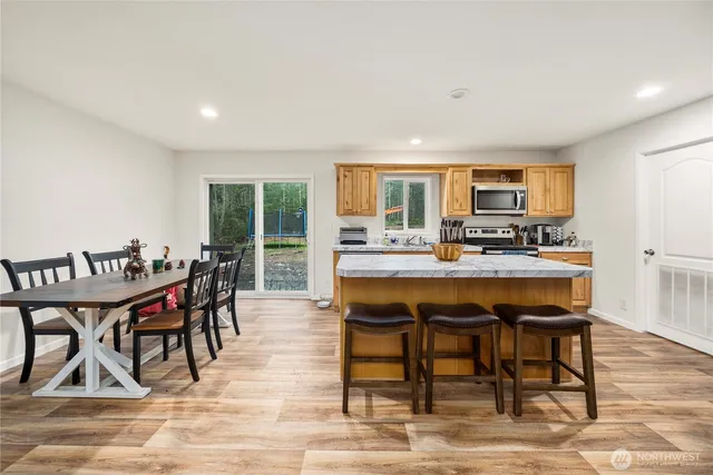a dinning table and chairs in a kitchen