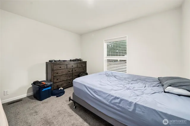a bedroom with a bed and dresser
