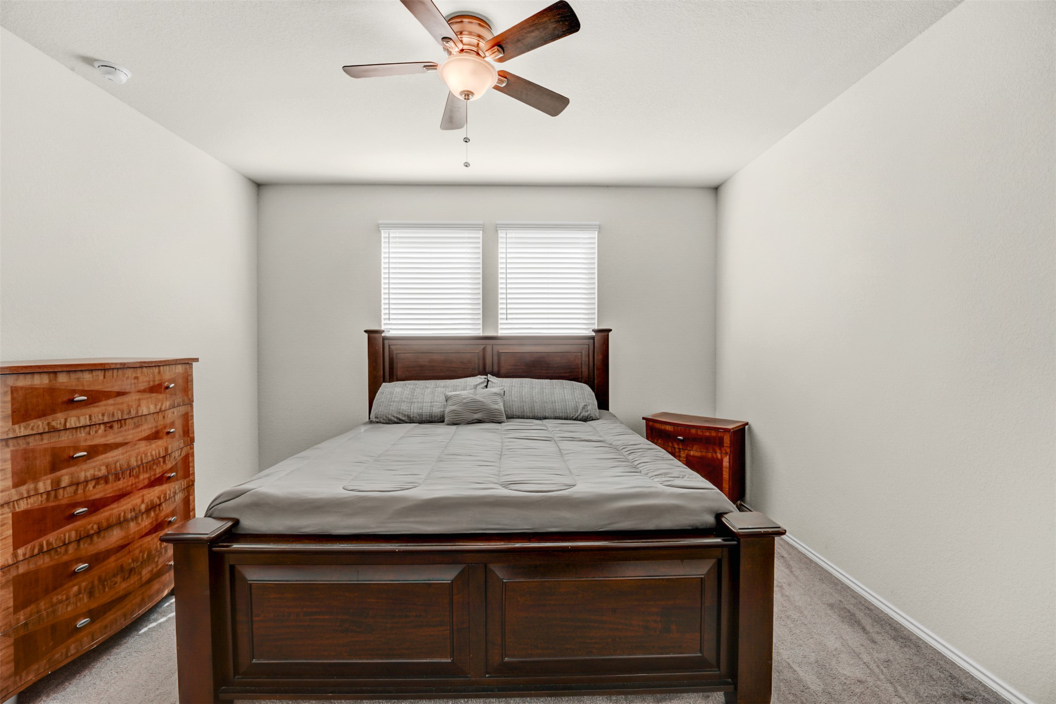 213 Ibis Falls Loop Jarrell, TX 76537 - Photo 16 of 37 A well-lit room featuring soft gray walls and comfortable flooring, creating a serene personal retreat.