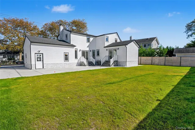 a view of a house with a big yard and potted plants