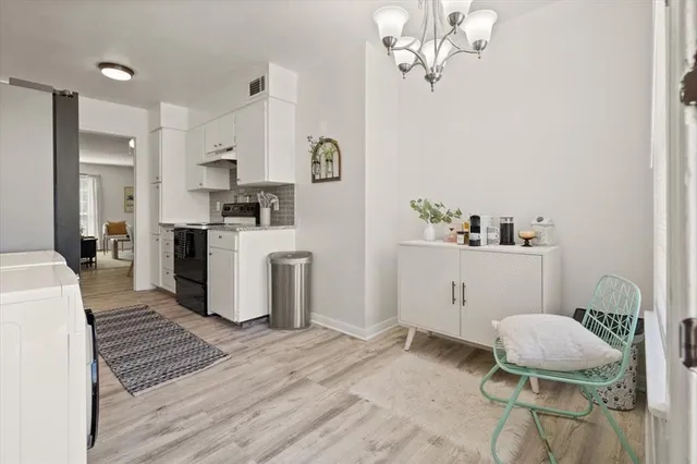 a spacious bedroom with a bed and a chandelier