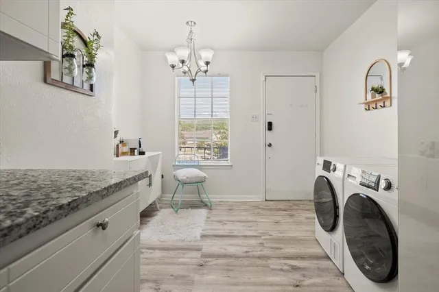 a bedroom with a bed a chandelier and closet