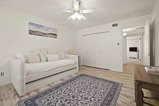 a bathroom with a granite countertop sink a toilet and a mirror