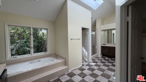 a bathroom with a bathtub and a shower