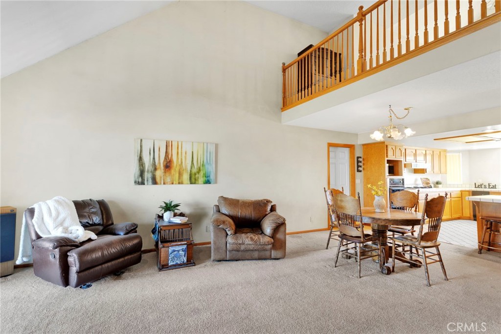 11062 Hollister Road Oak Hills, CA 92344 - Photo 11 of 69 a living room with furniture and a dining table with chair