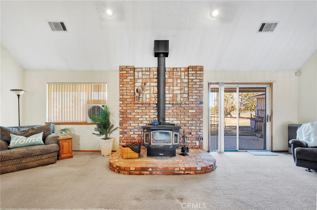 11062 Hollister Road Oak Hills, CA 92344 - Photo 13 of 69 a living room with furniture and a large window