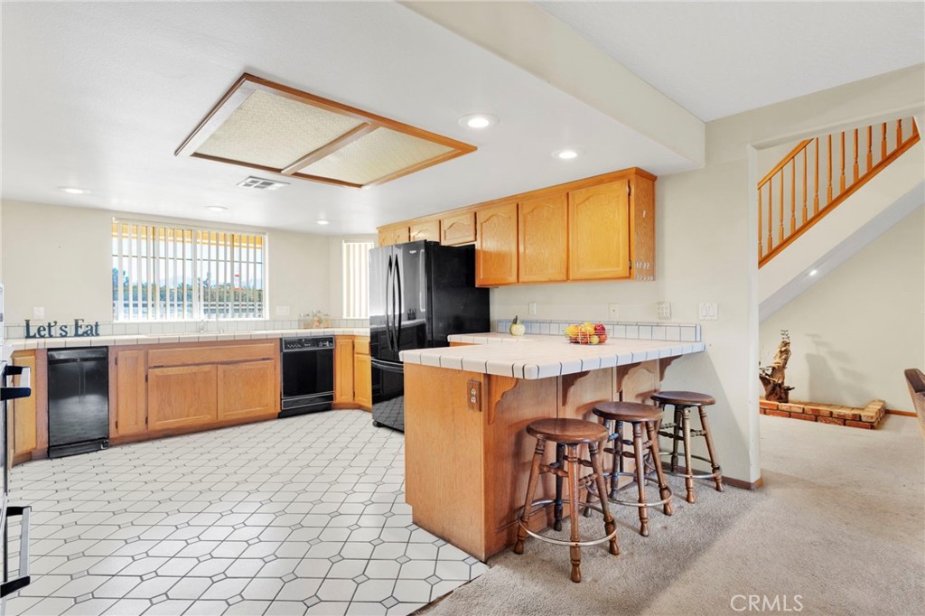 11062 Hollister Road Oak Hills, CA 92344 - Photo 15 of 69 a large kitchen with a table and chairs in it