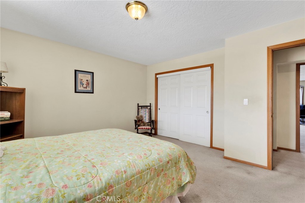 11062 Hollister Road Oak Hills, CA 92344 - Photo 25 of 69 a bedroom with a bed and a cabinets