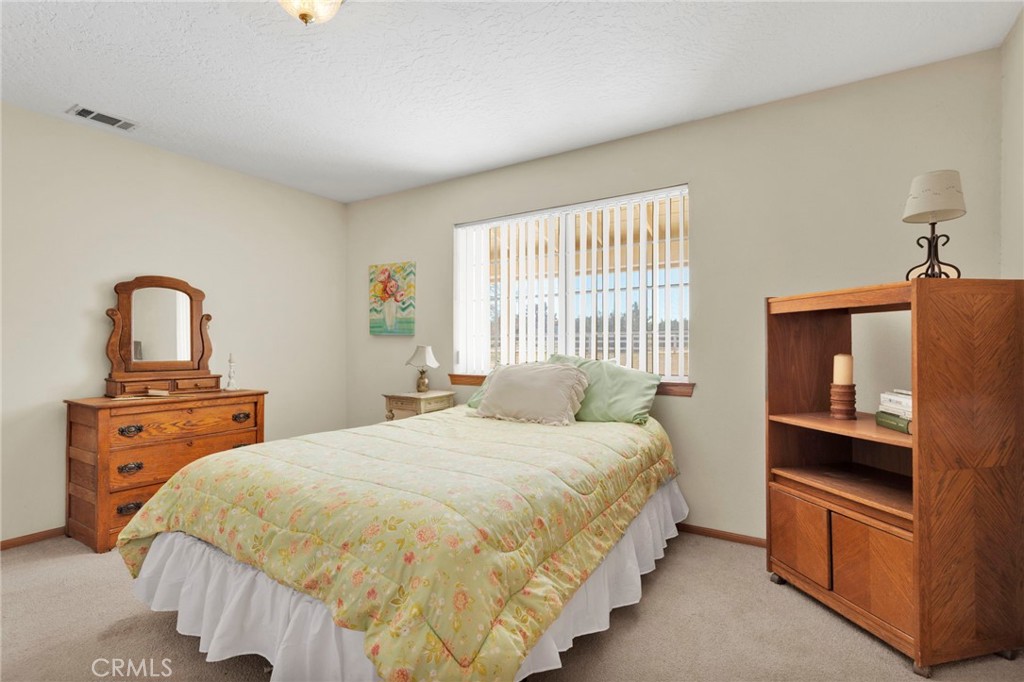 11062 Hollister Road Oak Hills, CA 92344 - Photo 26 of 69 a bedroom with a bed and a dresser
