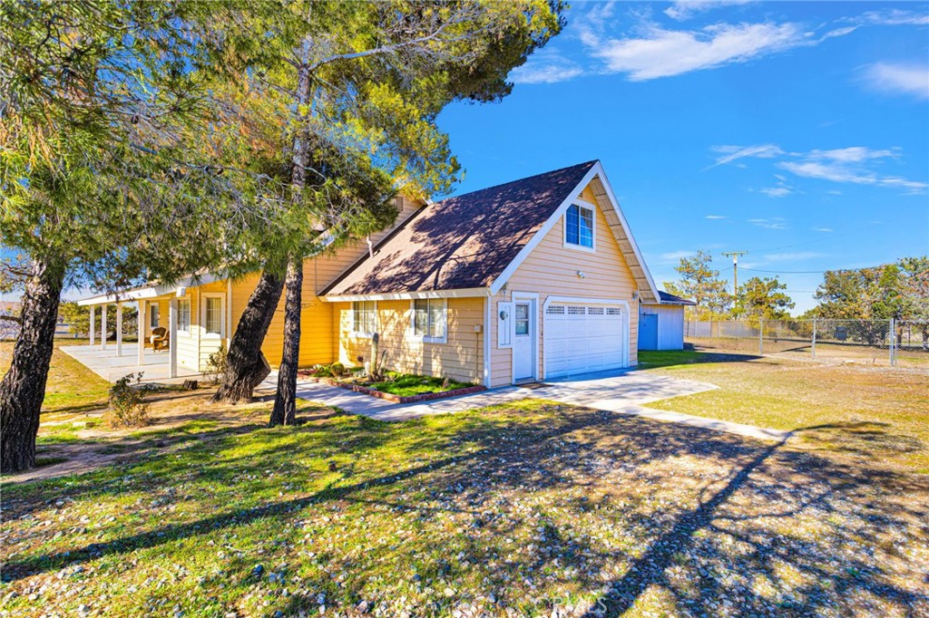 11062 Hollister Road Oak Hills, CA 92344 - Photo 3 of 69 a house with trees in front of it