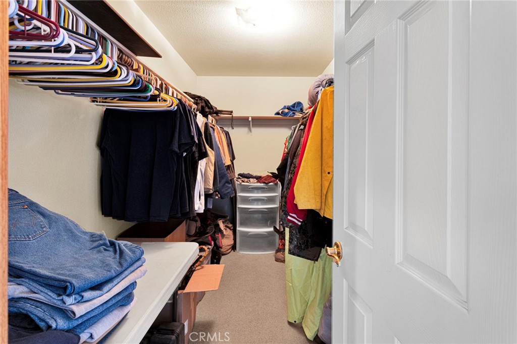 11062 Hollister Road Oak Hills, CA 92344 - Photo 34 of 69 a view of walk in closet with clothes and shoes